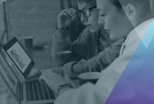 people working on a laptop and ipad