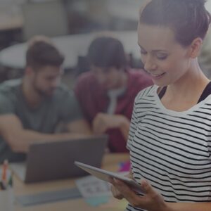 a women looking in the ipad and men looking in the laptop