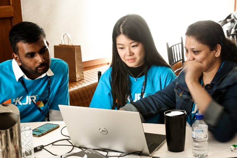 kjr team members working on the laptop