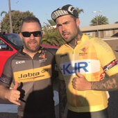 Two men clicking photo, one with KJR Tshirt