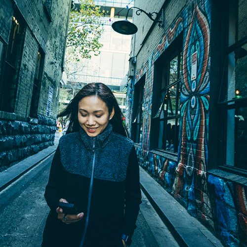 women walking and looking at her phone - KJR Explorers