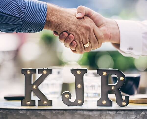 KJR two people shaking hands