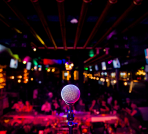 a picture of a microphone and the blurred audience in the background