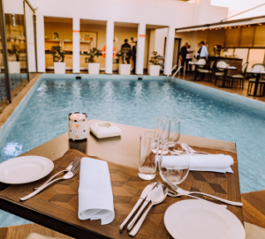 Photo of a resort picturing a floating dining table on the water of the pool