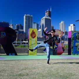 man posing in front on the brisbane name